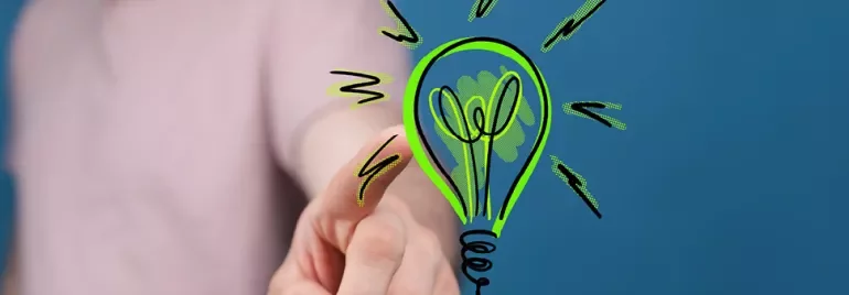 Main tendant un dessin d'ampoule lumineuse verte